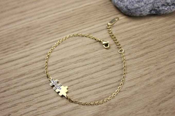 Bracelet puzzle en acier doré et zirconiums