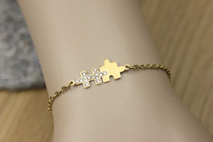 Bracelet puzzle en acier doré et zirconiums