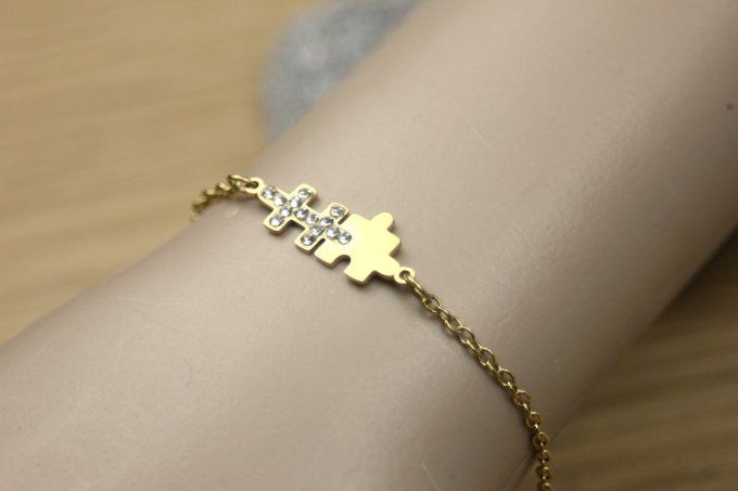 Bracelet puzzle en acier doré et zirconiums