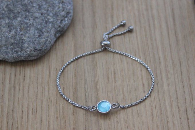 Bracelet acier cabochon rond en verre bleu fermoir perle stoppeur 