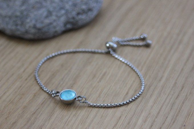 Bracelet acier cabochon rond en verre bleu fermoir perle stoppeur 