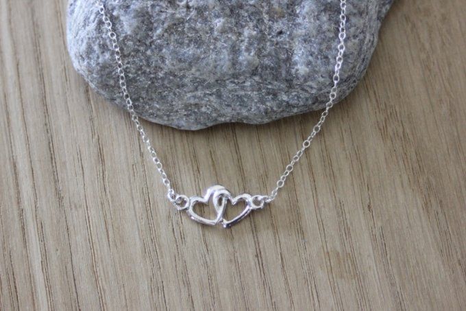 Collier ras de cou en argent massif de style minimaliste avec pendentif coeur entrelacés, le tout en